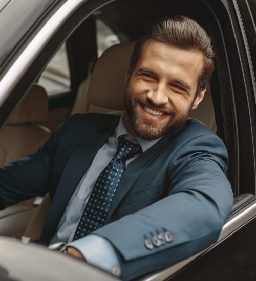 Elegant,Caucasian,Male,In,Suit,Sitting,At,The,Wheel,Of